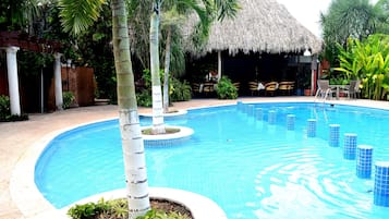 Alberca al aire libre y camastros