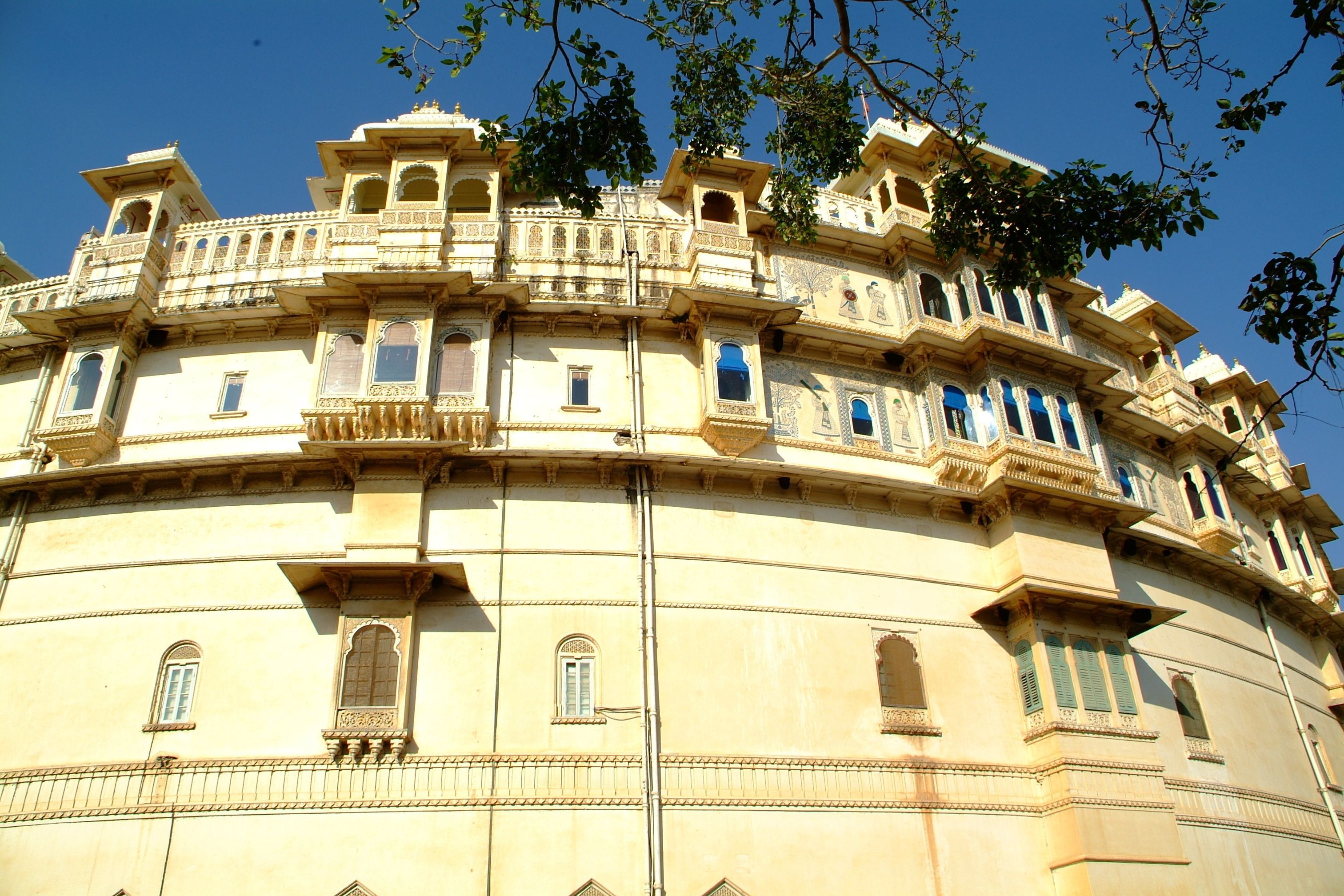A historic building with ornate balconies and arched windows.
