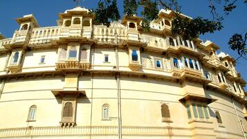 A historic building with ornate balconies and arched windows.