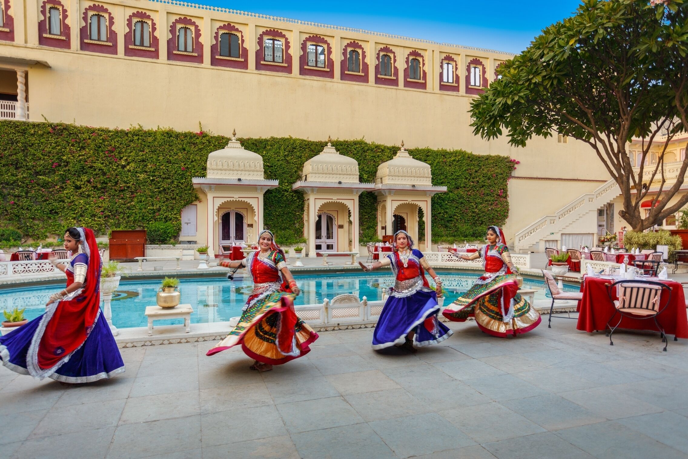A courtyard with a pool, traditional architecture, and outdoor seating.