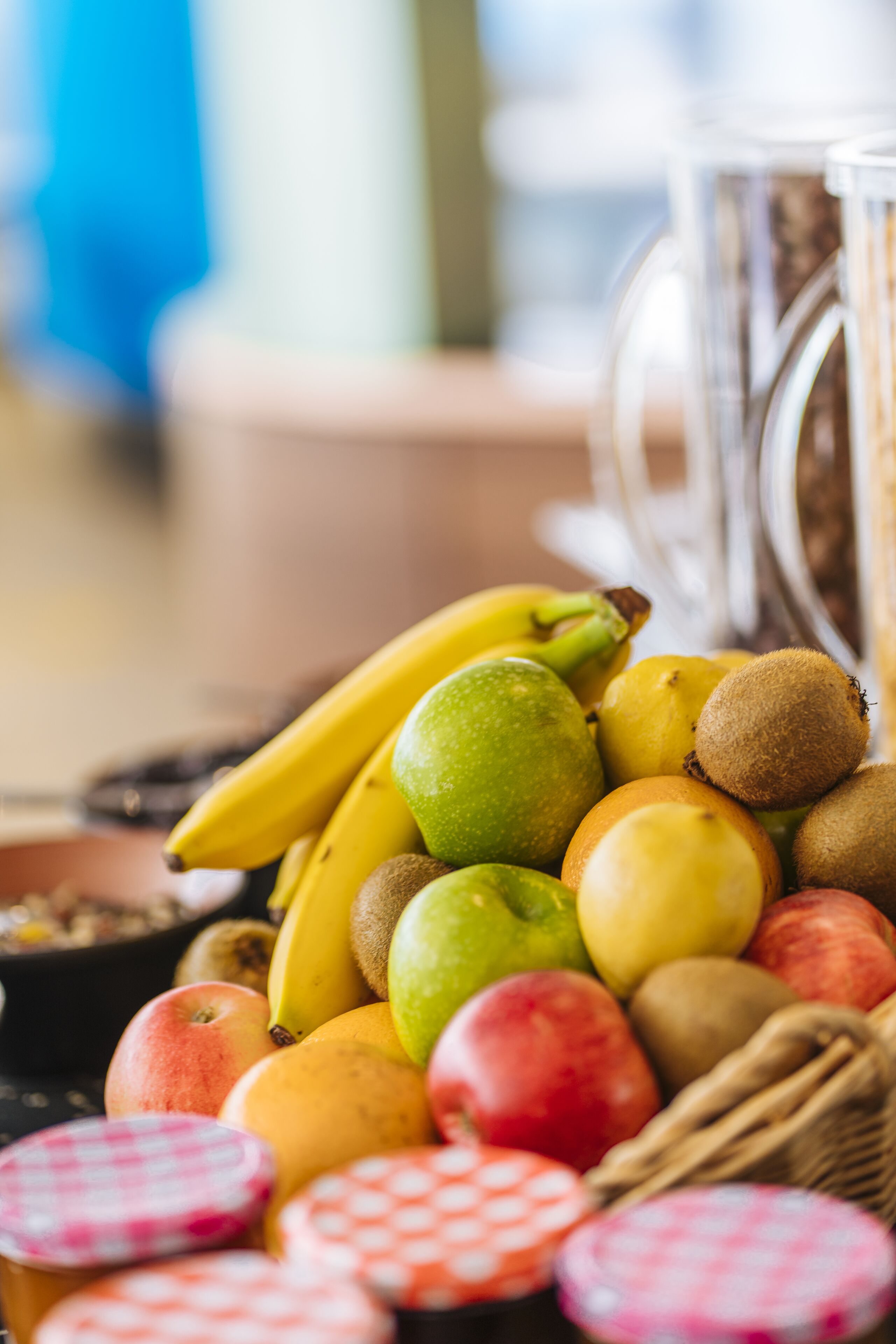 A variety of fruits including bananas, kiwis, and apples.