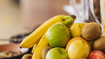 A variety of fruits including bananas, kiwis, and apples.