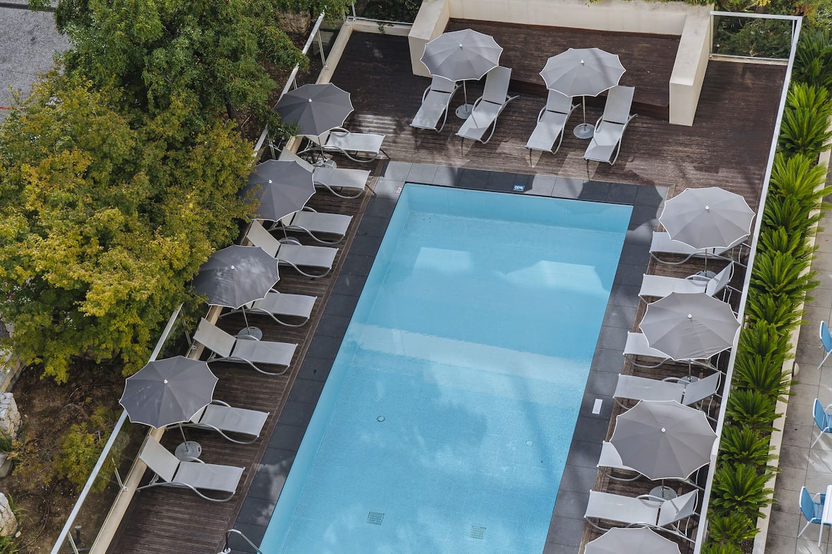 seasonal outdoor pool, open 9:00 am to 8:00 pm, pool umbrellas