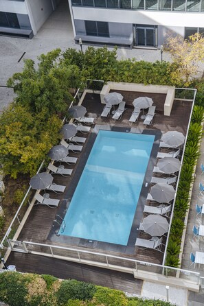 Seasonal outdoor pool, open 9:00 AM to 8:00 PM, pool umbrellas