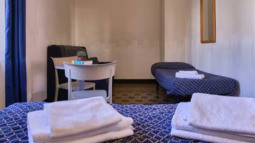 Relax in a cozy space with a comfortable bed, a small table, and a chair.
