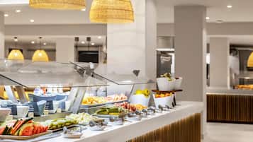 A buffet with various food items and a modern interior design.