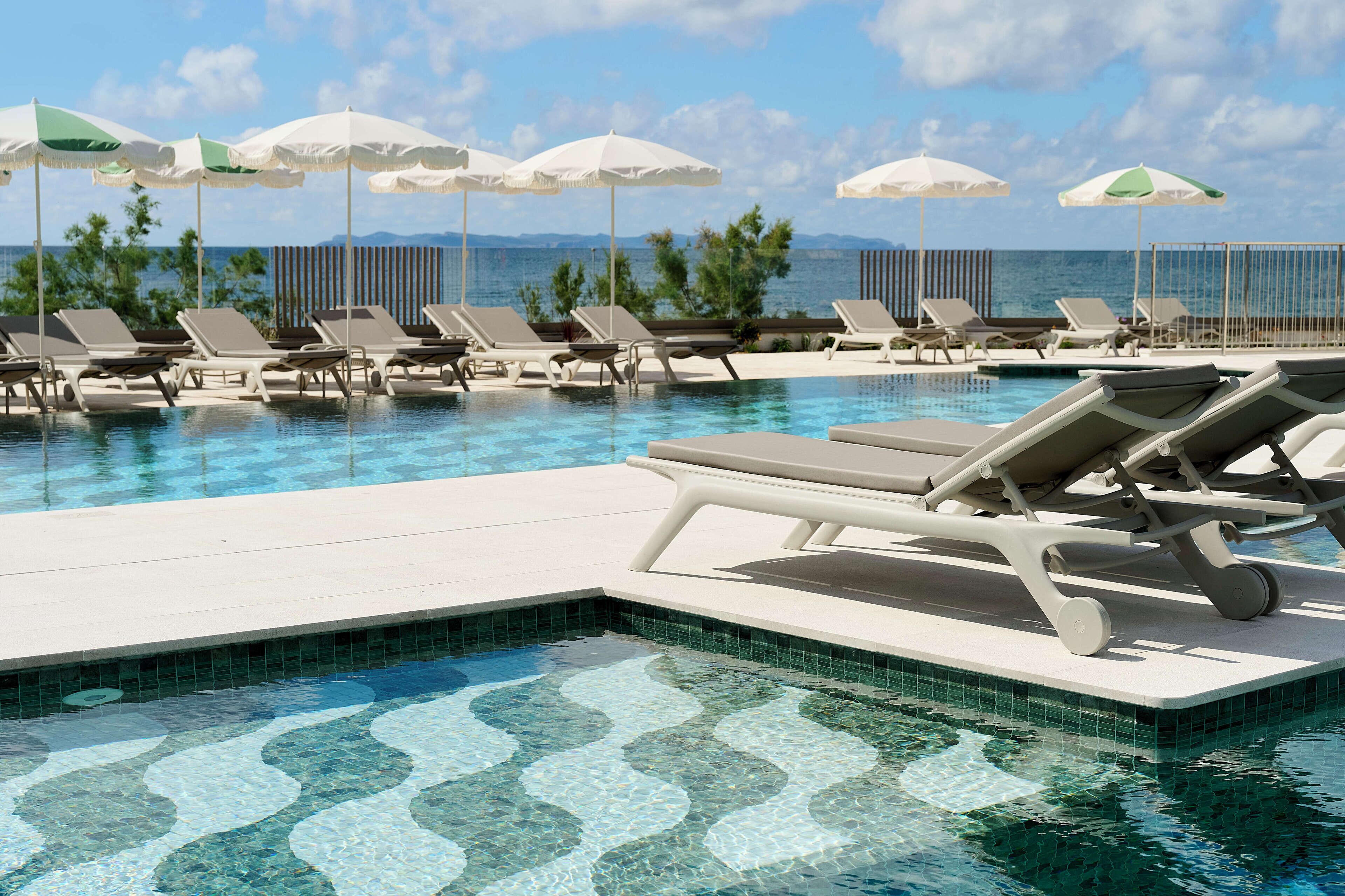 Seasonal outdoor pool, open 10:00 AM to 6:00 PM, pool umbrellas