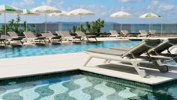 Seasonal outdoor pool, open 10:00 AM to 6:00 PM, pool umbrellas