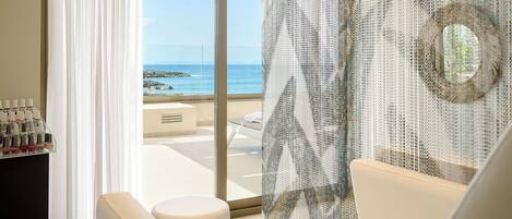 A modern bathroom with a large window, a white bathtub, and a shower area.