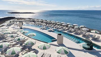 Seasonal outdoor pool, open 10:00 AM to 6:00 PM, pool umbrellas