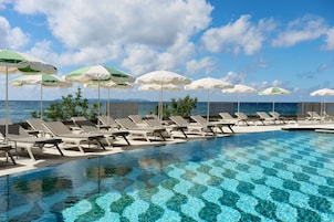 Seasonal outdoor pool, open 10:00 AM to 6:00 PM, pool umbrellas