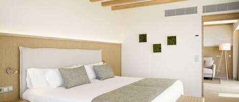 A modern bedroom with a large bed, wooden ceiling beams, a bedside table, and a bench.