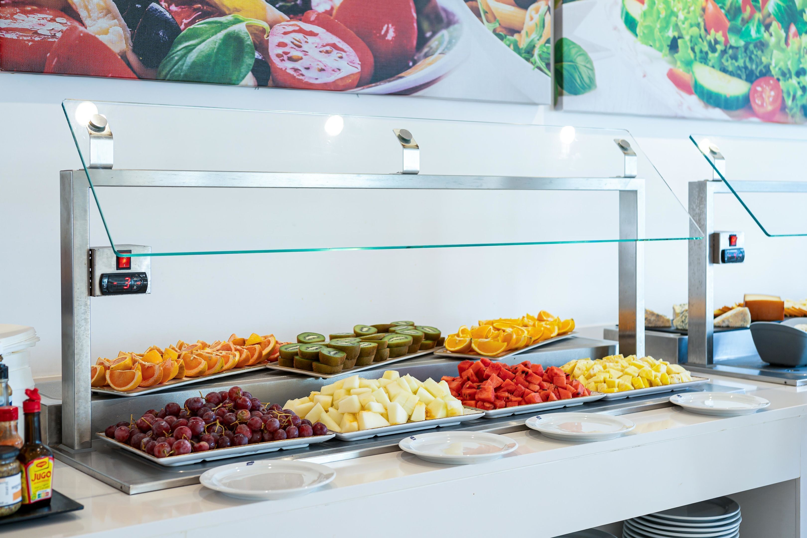 A buffet with various fruits and vegetables.