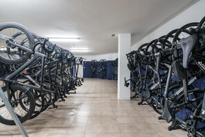 A bike rental facility with multiple bicycles parked in rows.