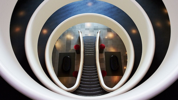 A spiral staircase with a central column and a circular railing. - Aviator Hampshire (Farnborough)