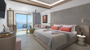 A modern hotel room with a large bed, a sitting area with a view, and a balcony. - Elysium Resort & Spa (Rhodes)