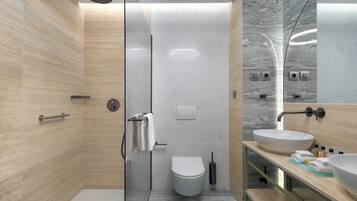 A modern bathroom with a glass-enclosed shower, a toilet, and a sink with a marble countertop.