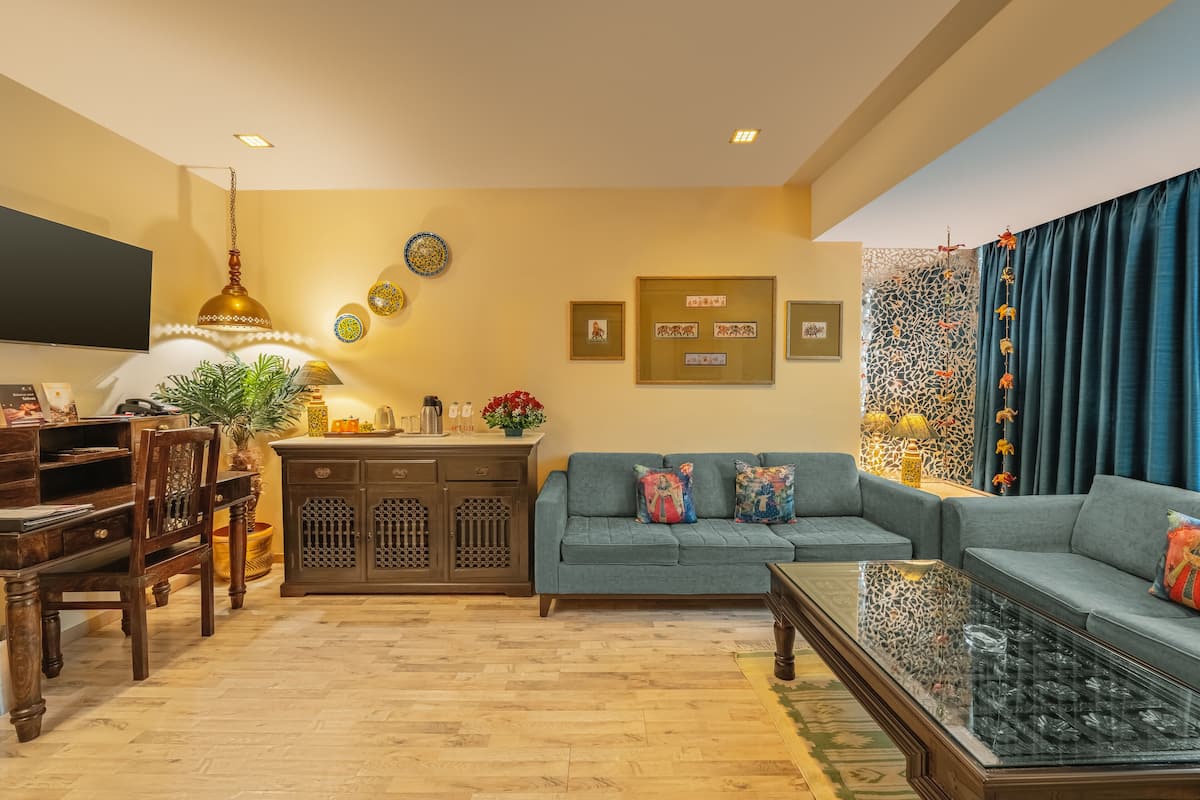 A living room with a sofa, coffee table, and wooden furniture.