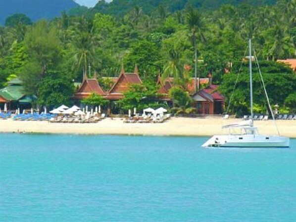 On the beach, white sand, sun loungers, beach umbrellas