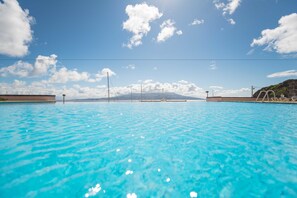 Relax by the serene pool surrounded by a well-maintained landscape and breathtaking mountain views.