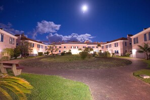 Stroll through the serene courtyard, surrounded by uniform buildings with flat roofs and evenly spaced windows.