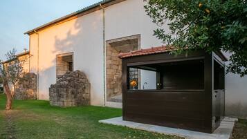 A modern building with a stone wall and a wooden structure.
