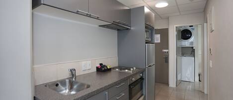 A modern kitchen with stainless steel appliances, a built-in microwave, and a dishwasher.