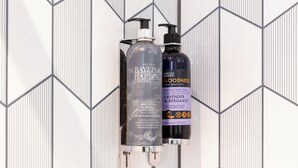 Two Baylis & Harding Elements bottles on a wall with a geometric pattern. - Premier Inn Köln City Mediapark (Cologne)