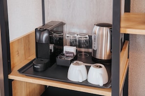 Prepare your favorite beverages with a coffee maker and kettle in this convenient kitchenette.