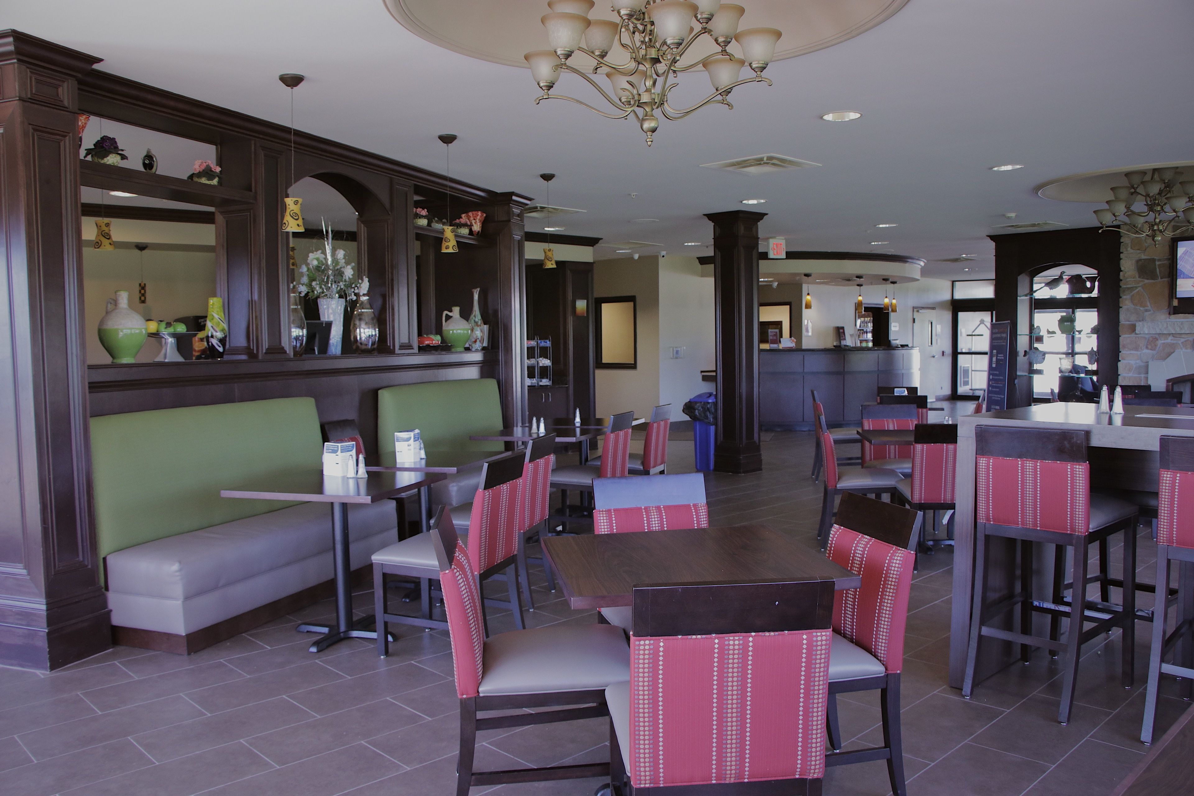 A restaurant with booths, high-top tables, and bar seating.