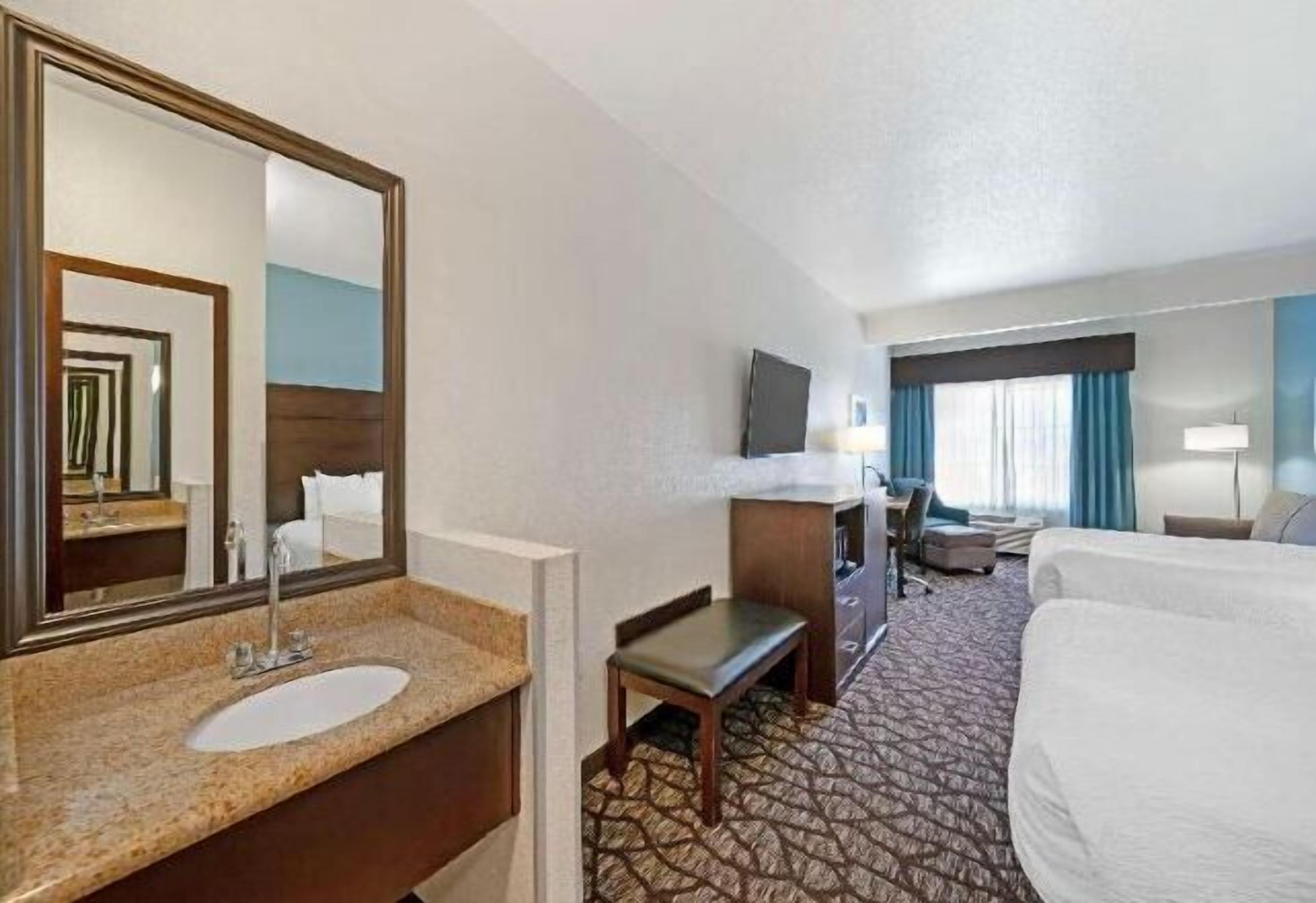 Premium bedding, desk, laptop workspace, blackout curtains