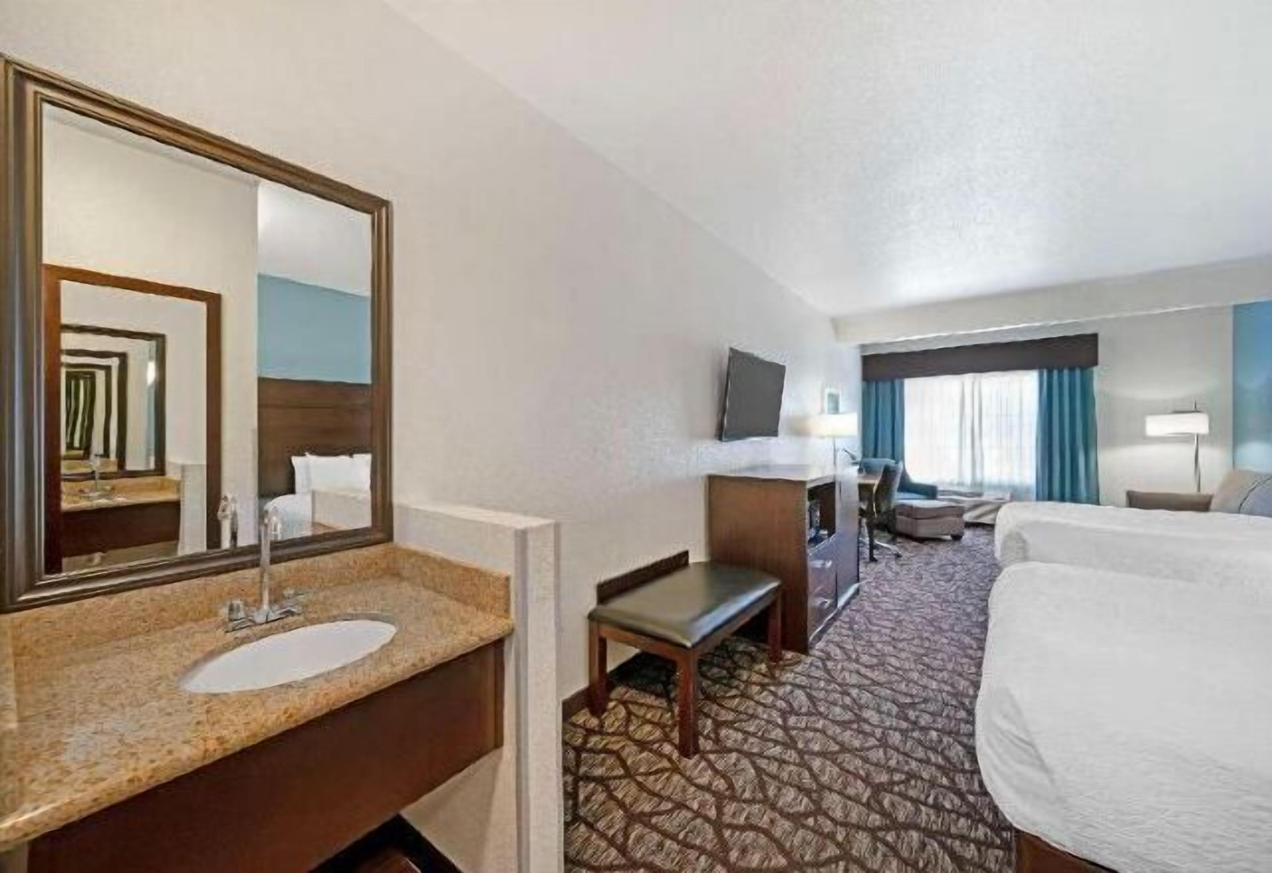 Premium bedding, desk, laptop workspace, blackout drapes