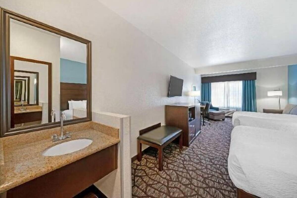 Premium bedding, desk, laptop workspace, blackout drapes