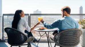 Two people sitting at a table with a drink, overlooking a cityscape. - Alma San Diego Downtown, a Tribute Portfolio Hotel (San Diego)