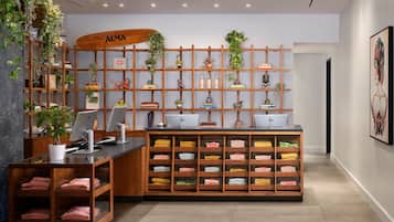 A modern office with wooden shelving, a desk with a computer, and neatly folded towels.