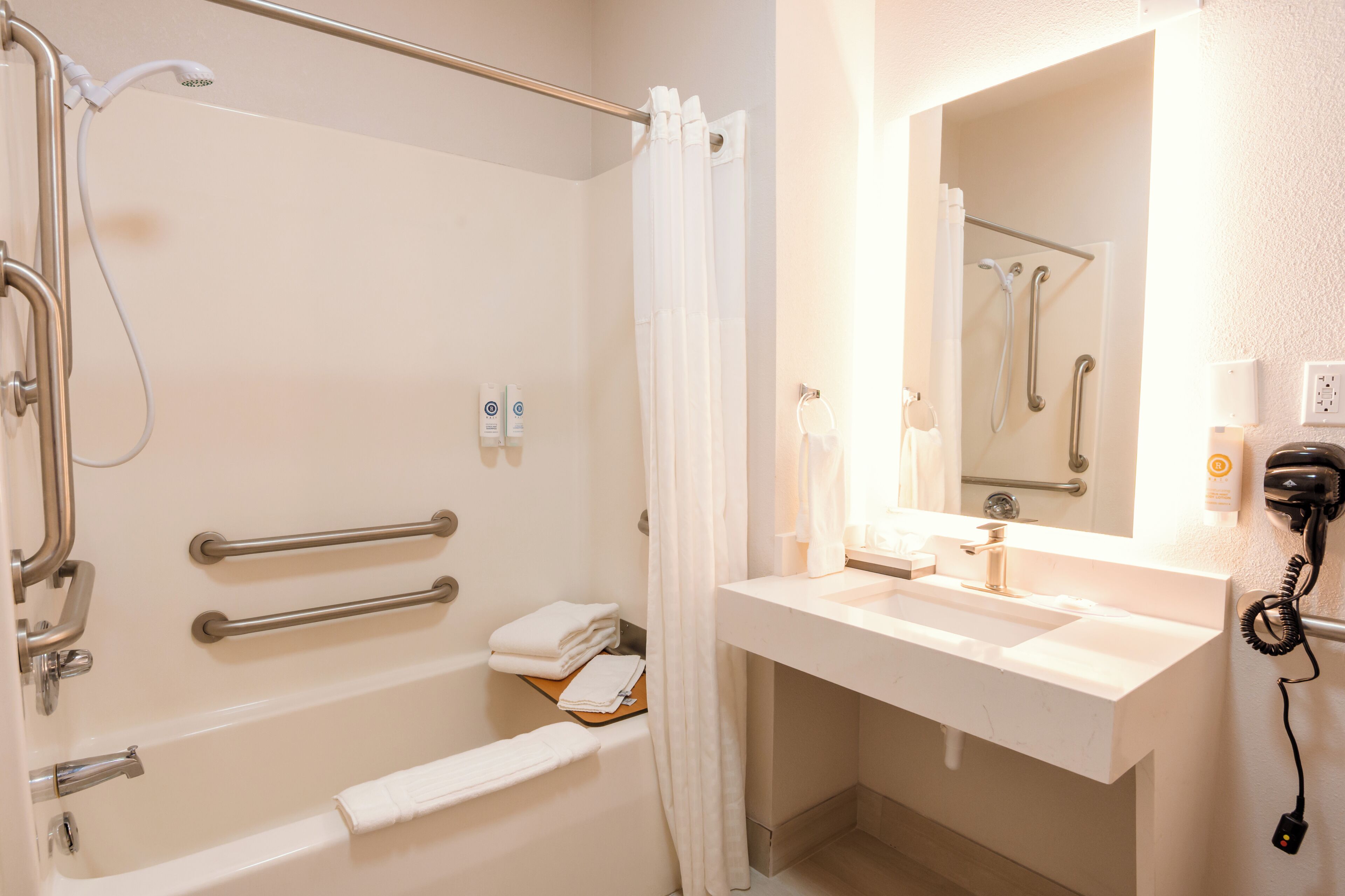 A bathroom with a bathtub, shower, and sink.