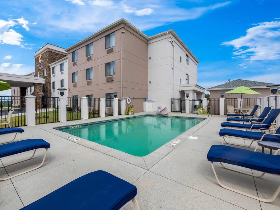 A hotel pool area with lounge chairs and a swimming pool.