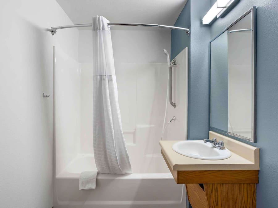 Combined shower/bathtub, towels, soap, toilet paper