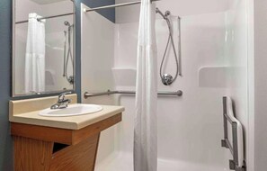 A bathroom with a shower, a sink, and a mirror. - Studio 6 Extended Stay Cincinnati Sharonville OH (Sharonville)