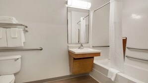 A modern bathroom with a toilet, sink, and bathtub.