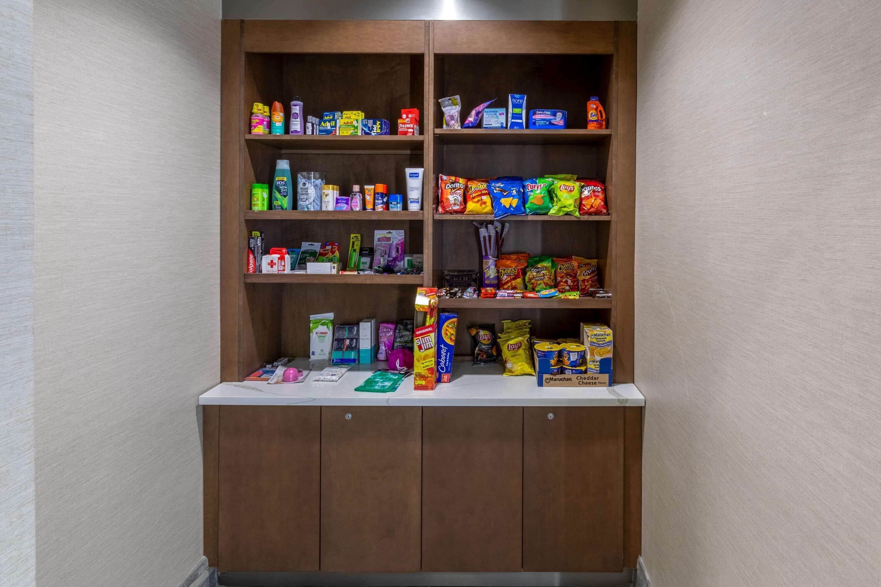 A shelf stocked with various snacks and beverages.