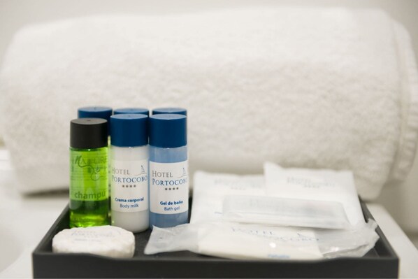 A hotel toiletry set including shampoo, body milk, and bath gel.