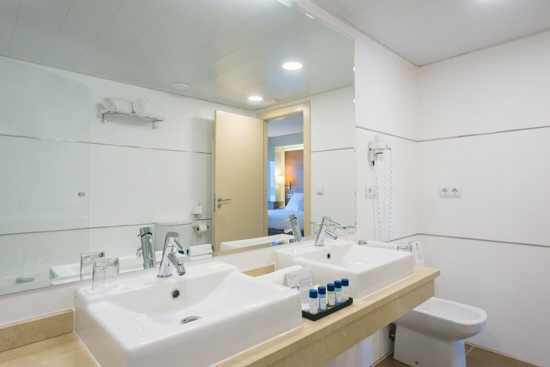 bathtub, hair dryer, bidet, towels