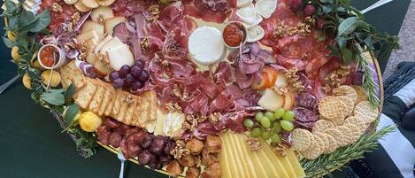 A charcuterie board with various cheeses, meats, and crackers.