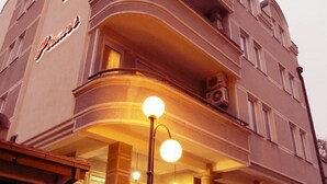A building with a curved facade and a sign that reads "Hotel." - Premier Hotel (Skopje)