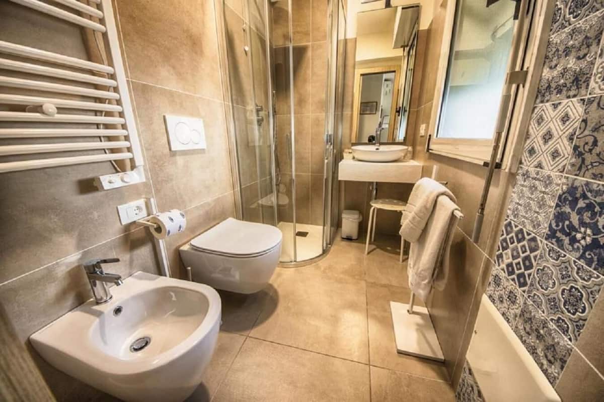 shower, hair dryer, bidet, towels