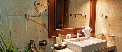 A modern bathroom with a large mirror, a sink, and a telephone.