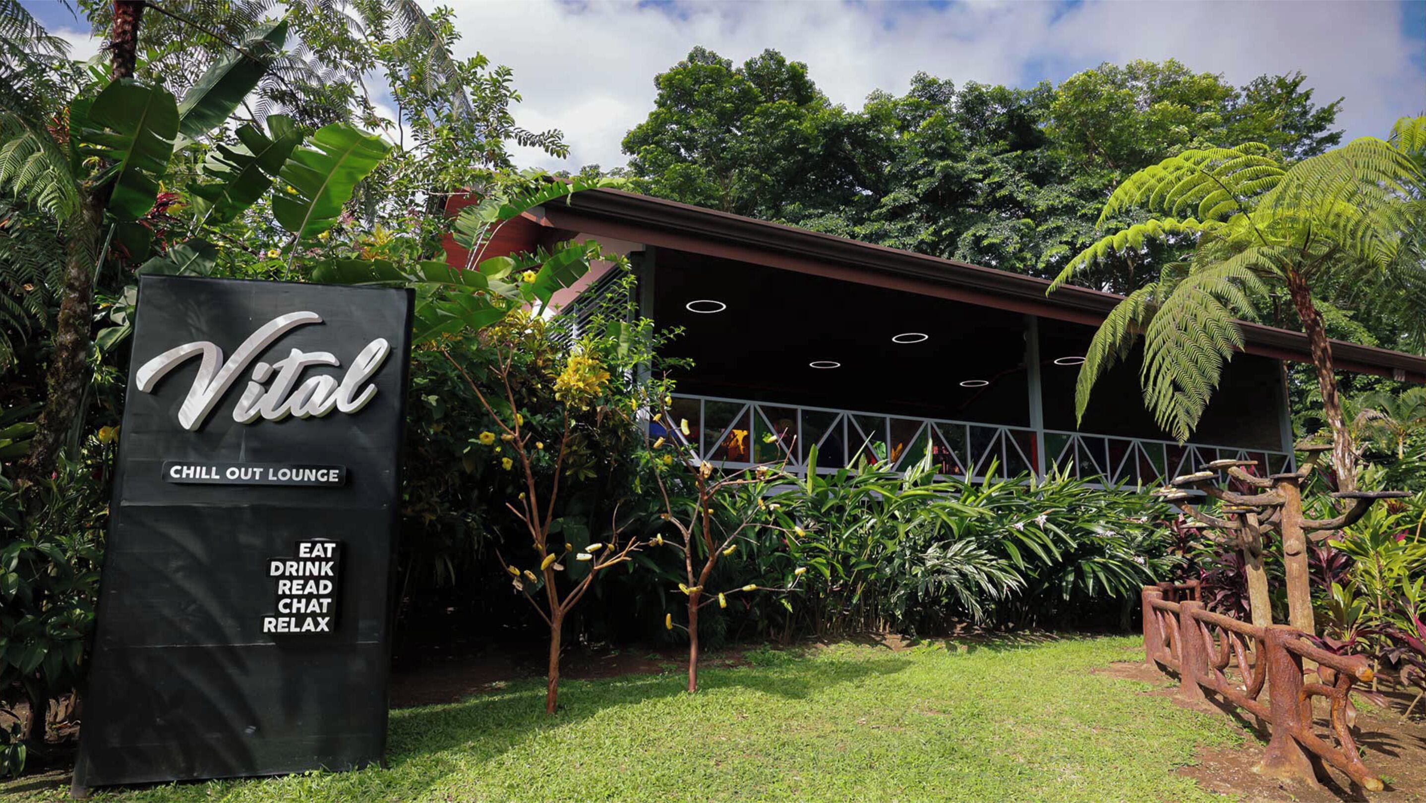 A sign for 'Vital Chill Out Lounge' with amenities listed: eat, drink, read, chat, relax.