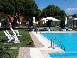 Seasonal outdoor pool, pool umbrellas, pool loungers