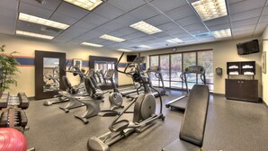 A gym with various exercise equipment, including treadmills, stationary bikes, and free weights. - Hampton Inn Wilmington - University Area/Smith Creek Station (Wilmington)